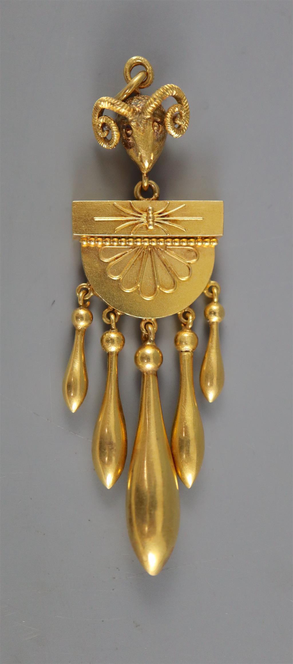 A Victorian Etruscan style gold, demi-lune and graduated five pear shaped drop pendant, with rams head bale,